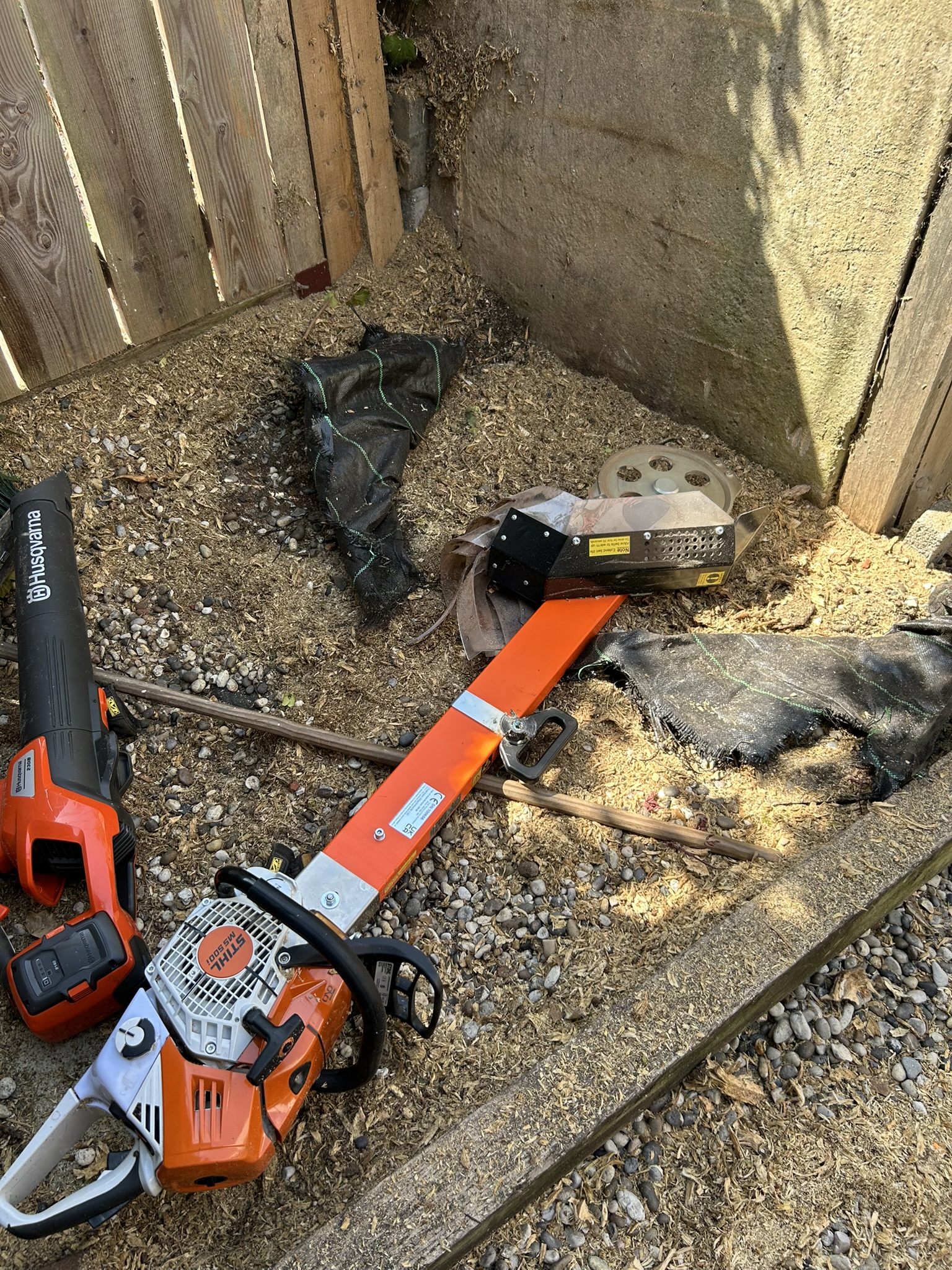 A compact tracked stump grinder reaching a stump through a narrow access route