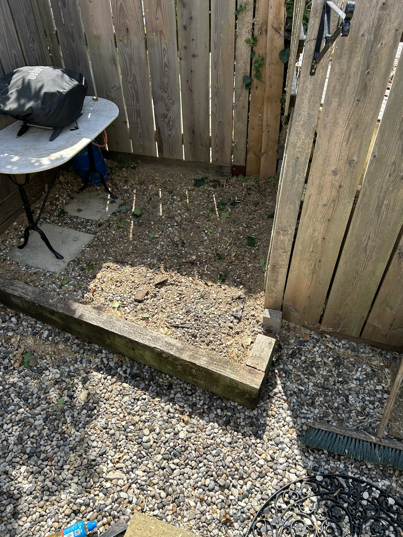The garden corner cleared and raked back to gravel after the stump was removed